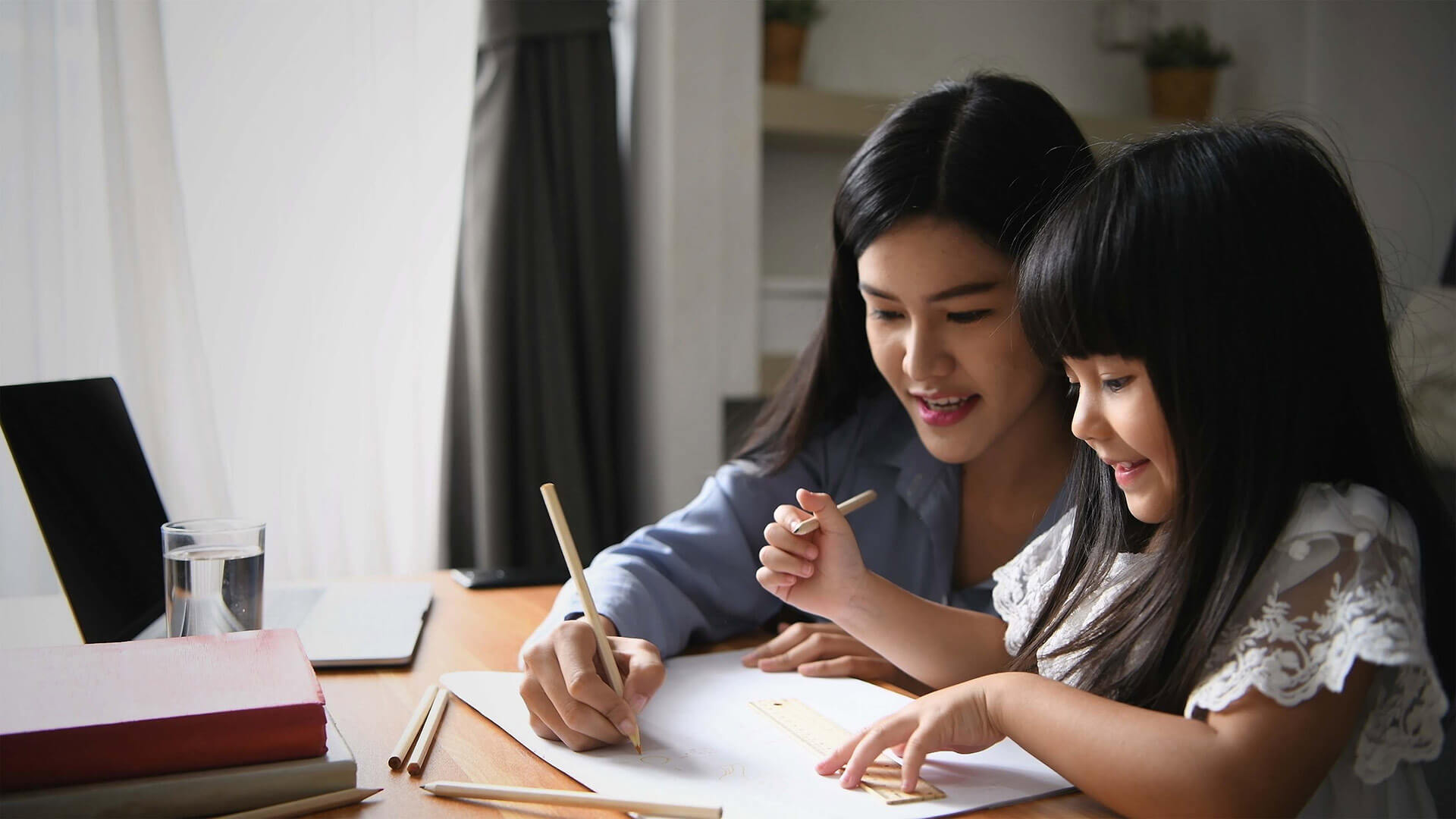 child learning at home with mother